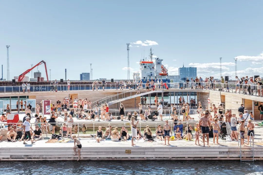 民眾在木甲板上曬太陽 wood deck  丹麥阿爾路斯港口浴場 水上公共空間 公共游泳池 Aarhus Harbor Bath Havnebadet PUblic Swimming Pool／BIG Bjarke Ingels Group