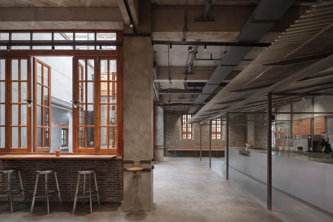 Shanghai BLUE BOTTLE藍瓶咖啡張園店／如恩設計 新舊對望：鋼構結合沖孔板，與磚牆形成對應、新桌子與舊木椅、舊建築與新結構