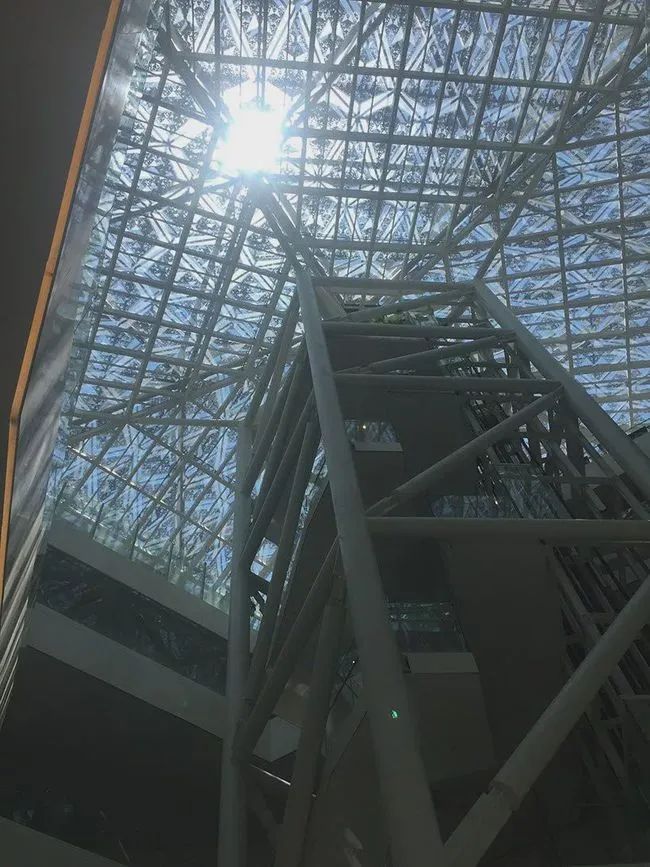 有別於一館翻修老宅的模式，二館從平底而起，作為新美術館的主建築設計師坂茂，在走訪台南後，感受炙熱氣候大幅降低民眾接觸戶外空間的興致，於是心想若能提供一處具遮蔭效果的戶外平台，不僅得以阻擋烈日直射曝曬，具通風換氣的空間，也能成為城市中的心有機綠空間。由於公十一區域腹地不大，為此團隊企圖創造一個立體化的美術館園地，既能作為藝術展示，也能夠垂直化營運