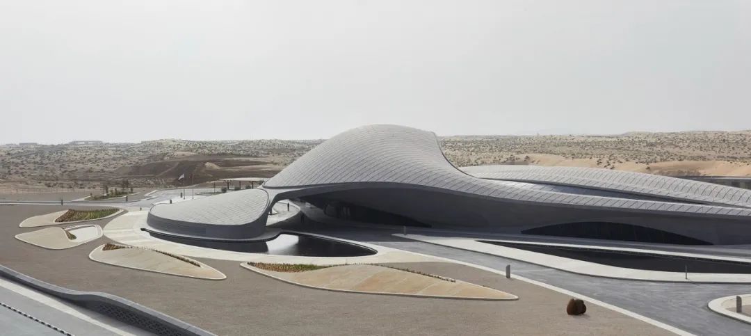 宛如沙丘的流暢曲線優雅演繹建築女帝Zaha Hadid的招牌曲線語彙與幾何線條，與散佈在周圍沙漠中的自然沙丘交相呼應，獨特的建築設計不僅在外觀上模仿了當地沙丘，而且還進一步優化了該地區的環境條件，讓建築成為自然的具體延伸