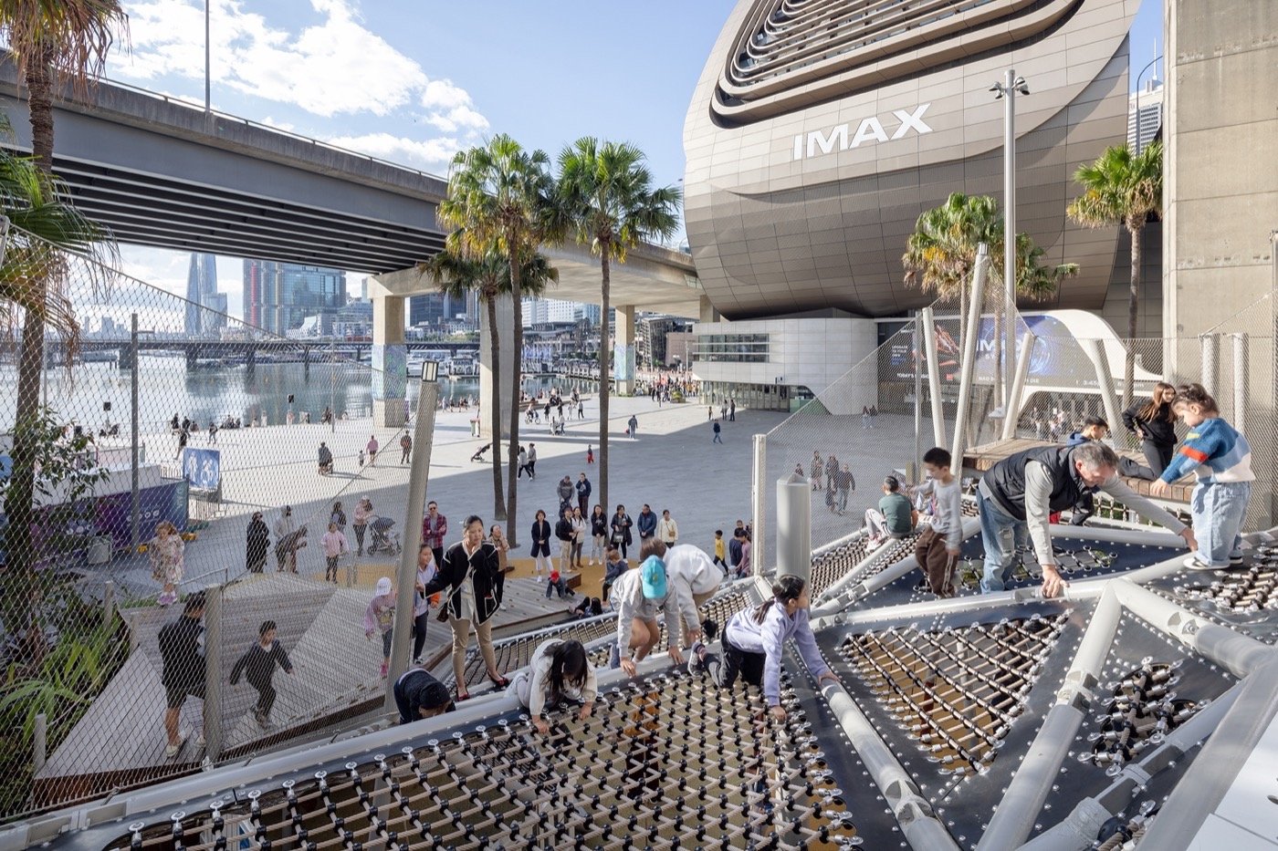 Darling Harbour Playground 雪梨達令港兒童遊戲場 溜滑梯 景觀設計 Aspect Studios  Aspect Studios  設計團隊運用棕櫚樹及植栽綠帶妝點環境，軟化都市硬體公共設施，吸引各年齡層市民駐足活動，展現雪梨水岸公共空間的蛻變魅力