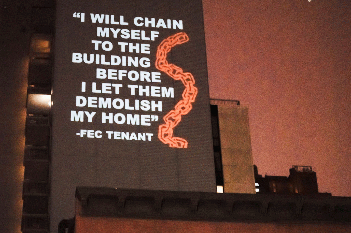 projection on building protesting the Fulton-Elliot Chelsea Demotion plan